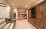 5th bedroom with twin bunk bed, flat screen TV, and en-suite bathroom